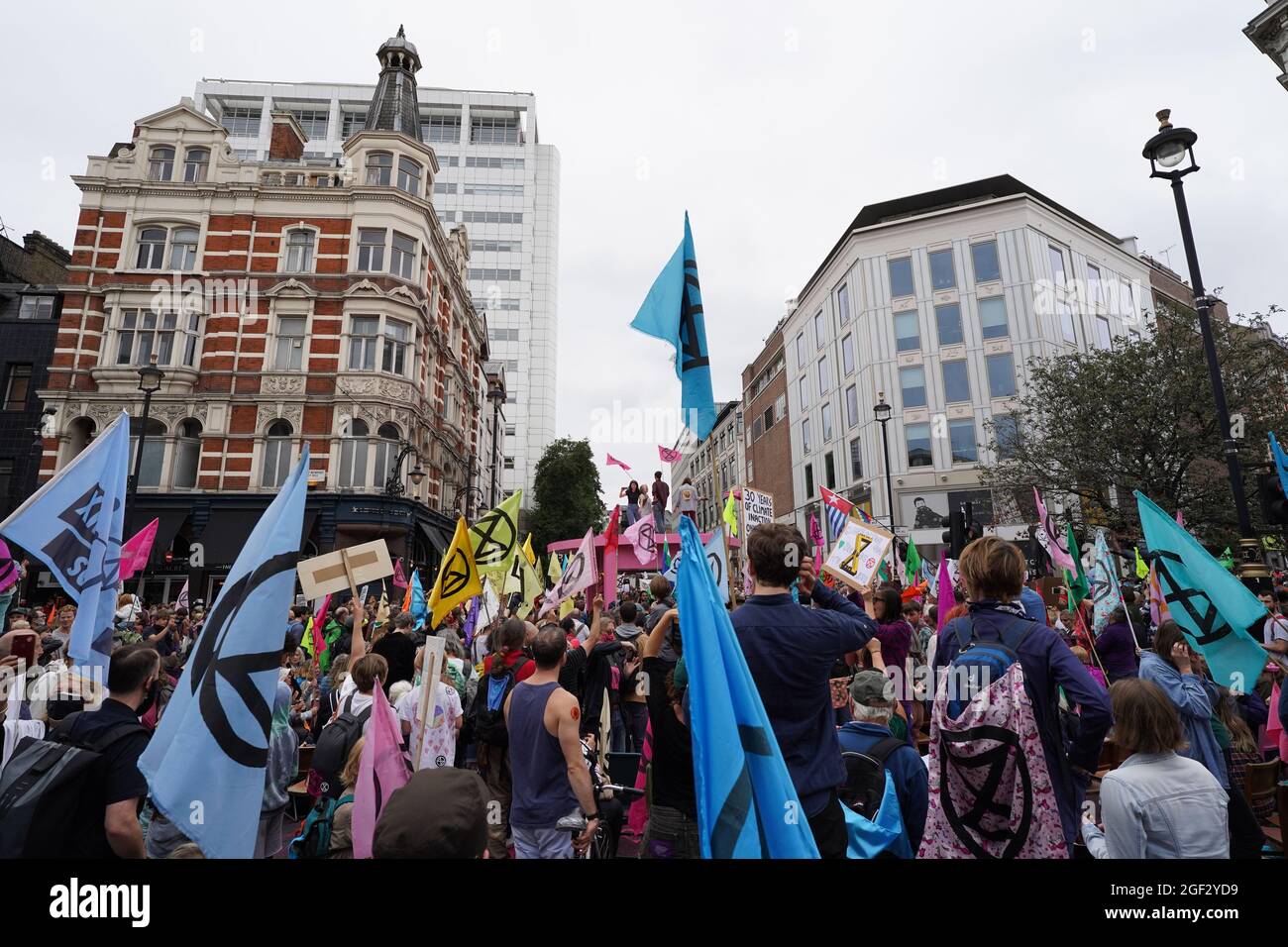 I manifestanti si riuniscono durante una protesta da parte dei membri della ribellione di estinzione vicino a Covent Garden, nel centro di Londra, all'inizio di una prevista azione di due settimane da parte del gruppo di protesta per il cambiamento climatico. Data foto: Lunedì 23 agosto 2021. Foto Stock