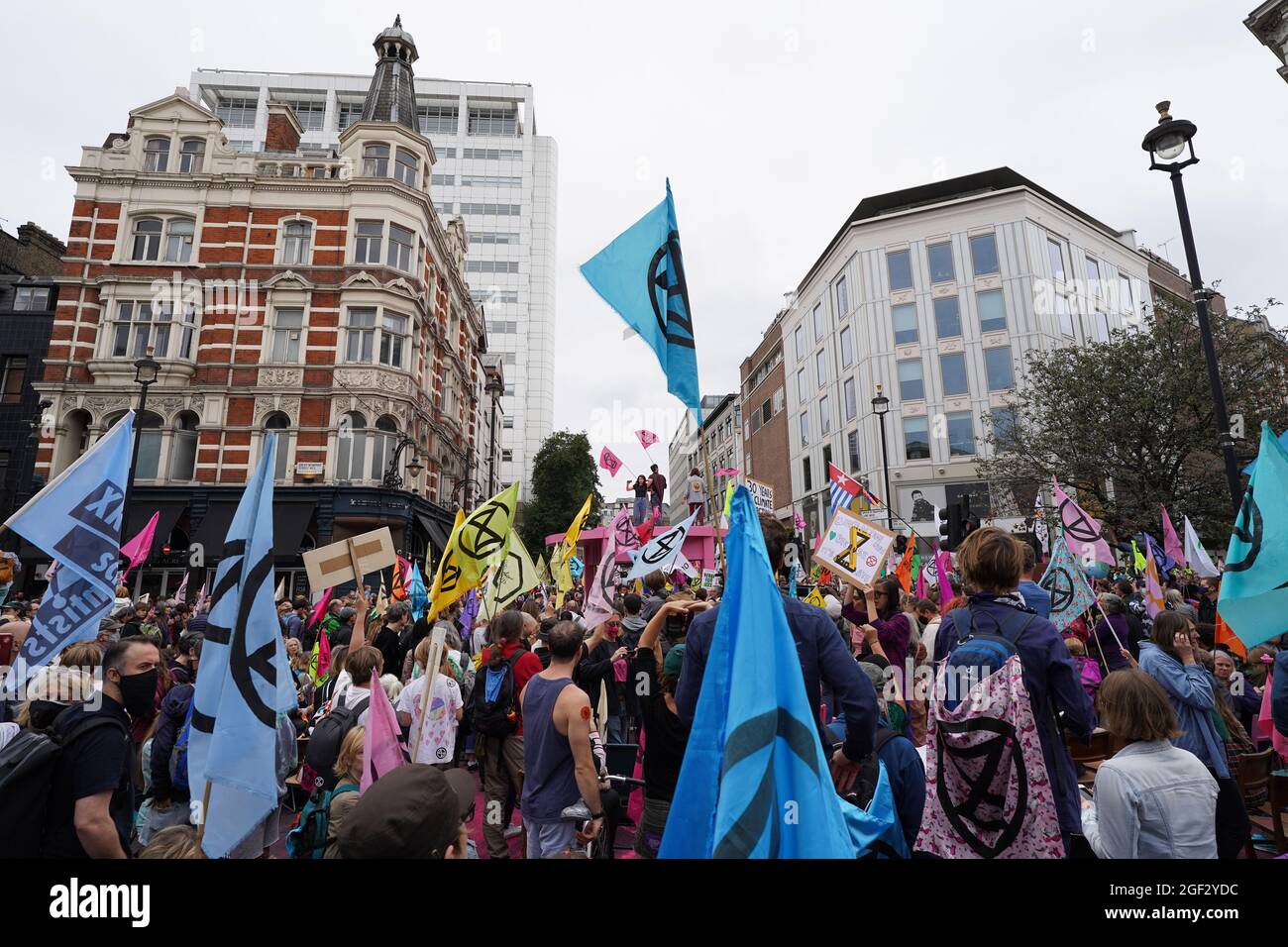 I manifestanti si riuniscono durante una protesta da parte dei membri della ribellione di estinzione vicino a Covent Garden, nel centro di Londra, all'inizio di una prevista azione di due settimane da parte del gruppo di protesta per il cambiamento climatico. Data foto: Lunedì 23 agosto 2021. Foto Stock