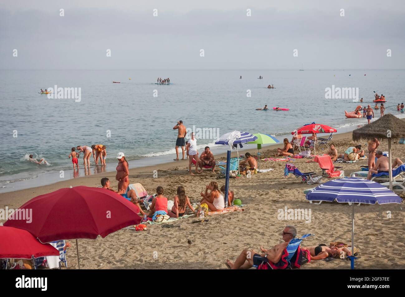 Spiaggia trafficata in estate a Fuengirola, in una giornata nuvolosa, durante la crisi pandemica, Costa del Sol, Spagna. Foto Stock