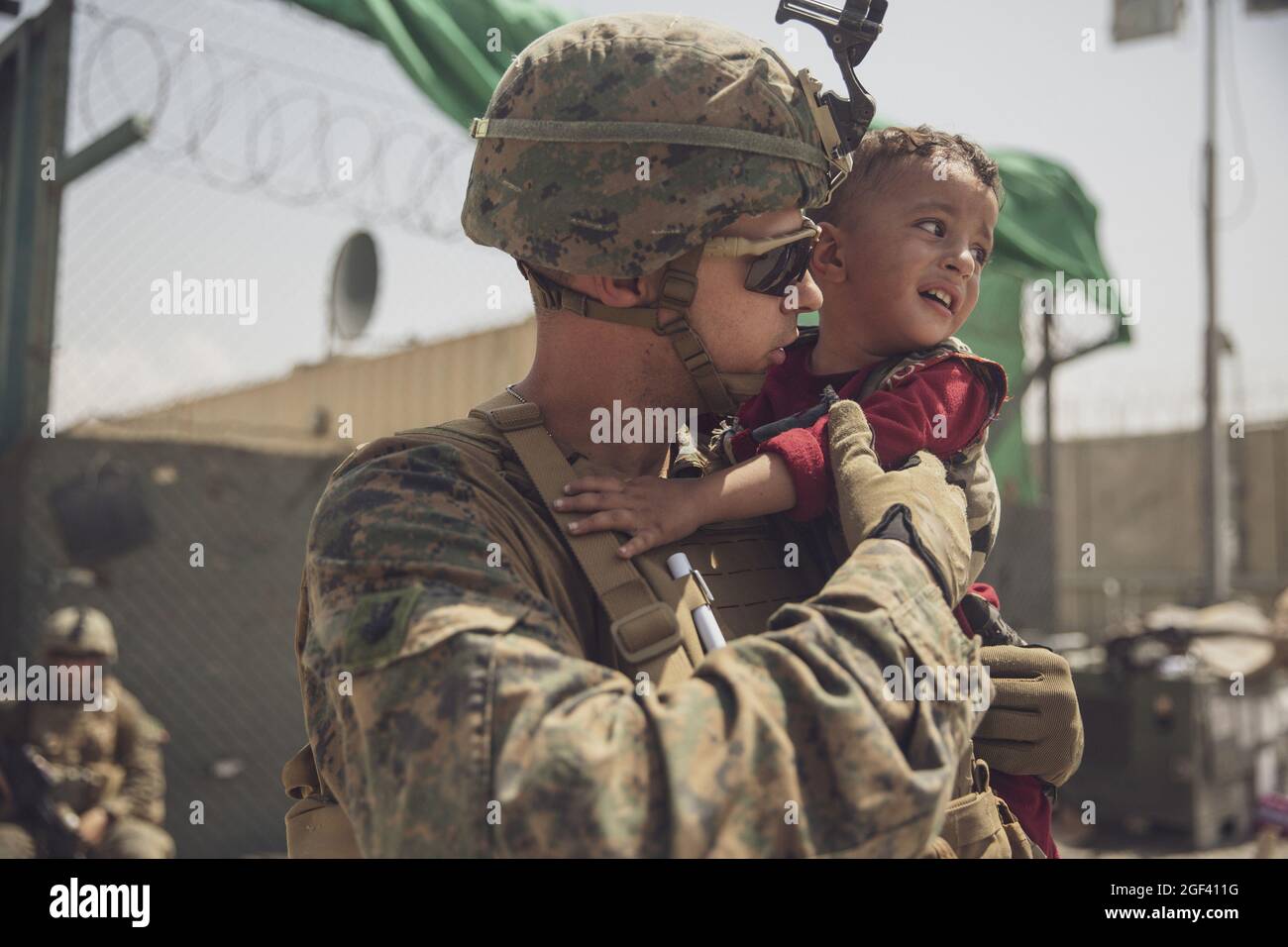 Kabul, Afghanistan. 23 Agosto 2021. La marina statunitense con la 24a unità di spedizione marina (MEU) calma un bambino che piange durante un'evacuazione all'aeroporto internazionale Hamid Karzai, a Kabul, Afghanistan, il 22 agosto, 2021. I membri del servizio degli Stati Uniti stanno assistendo il Dipartimento di Stato con un'operazione di evacuazione non combattente (NEO) in Afghanistan. Foto dello staff Sgt. Victor Mancilla/USMC/UPI Credit: UPI/Alamy Live News Foto Stock