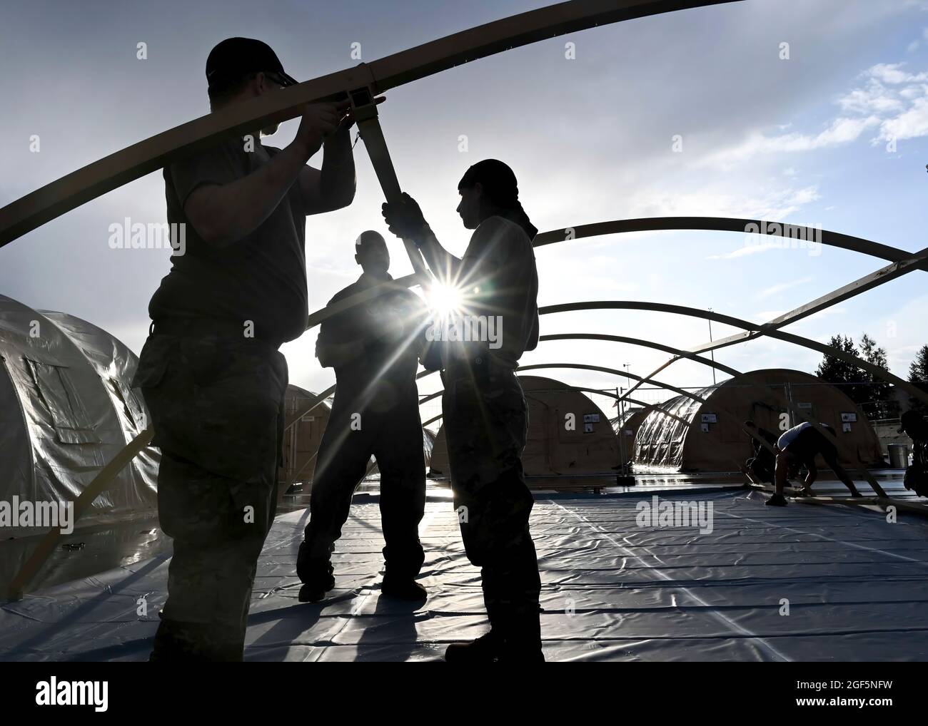 Gli airmen sollevano lo scheletro di un pod che ospiterà gli evacuati durante l'operazione Allees Refuge a Ramstein Air base, Germania, 22 agosto 2021. Questi pod possono essere messi in su in meno di 20 minuti e sono in grado di ospitare fino a 26 persone. (STATI UNITI Foto Air Force di Senior Airman Caleb S. Kimmell via American PhotoArchive/Alamy) Foto Stock