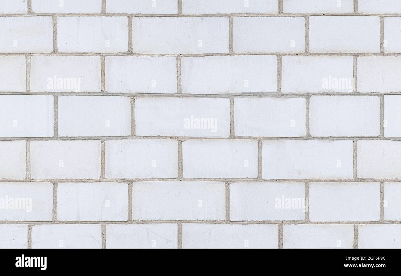 Parete di mattoni bianchi texture senza giunture. Sfondo bianco in cemento. Foto Stock