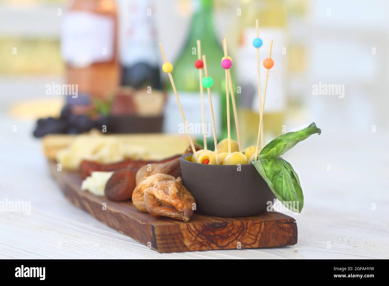 Salumi italiani con cracker di formaggio e salumi serviti su tavola di legno con bordo di corteccia grezzo Foto Stock