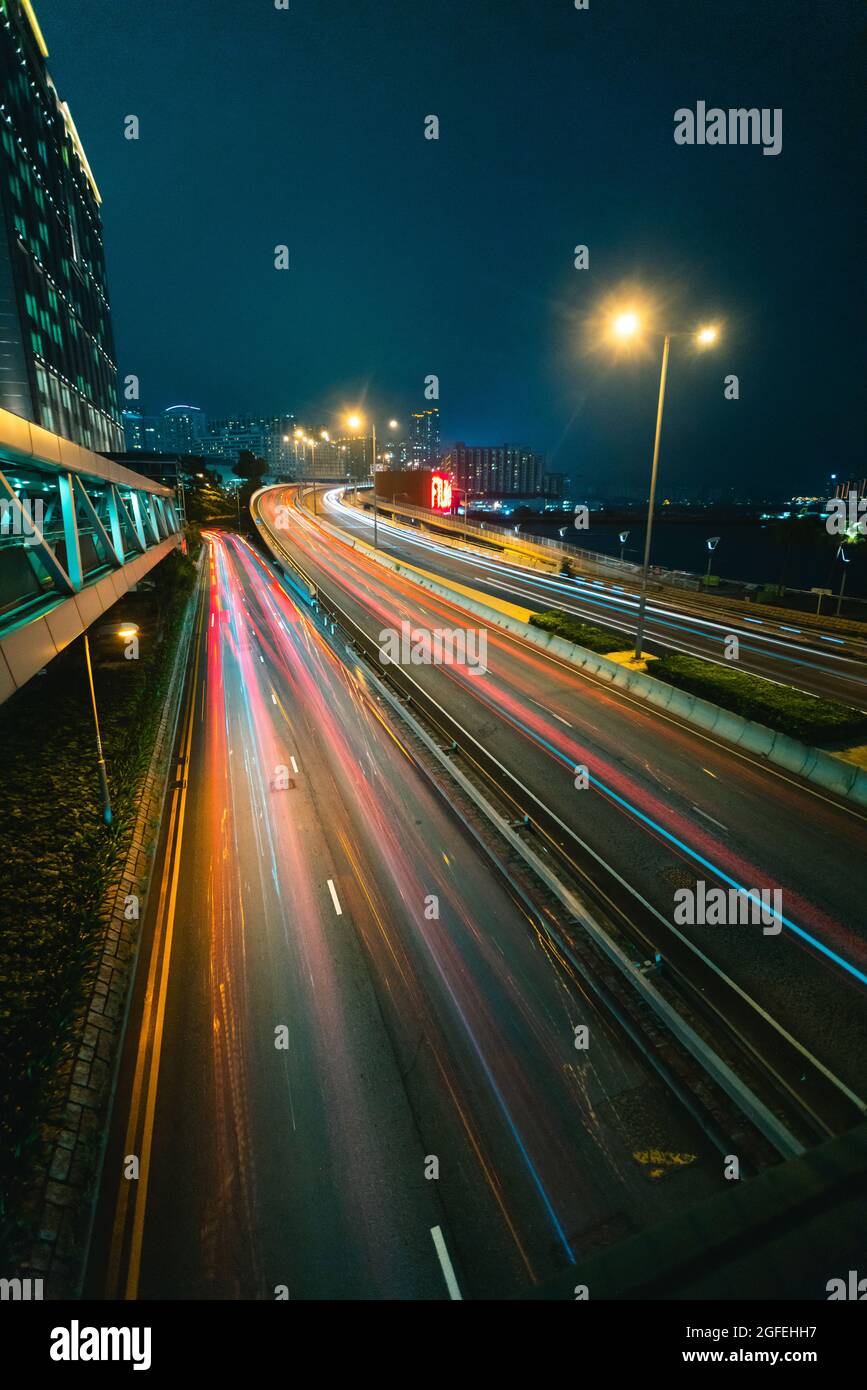 Lunga esposizione del traffico che si muove sul ponte durante il tramonto, Hong Kong Foto Stock