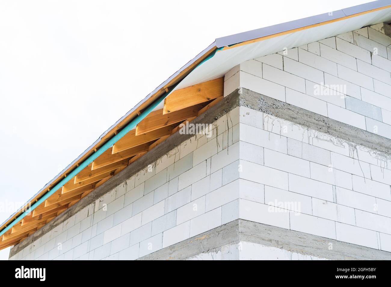 Grondaie sovrastano il tetto di una casa privata nel processo di costruzione Foto Stock