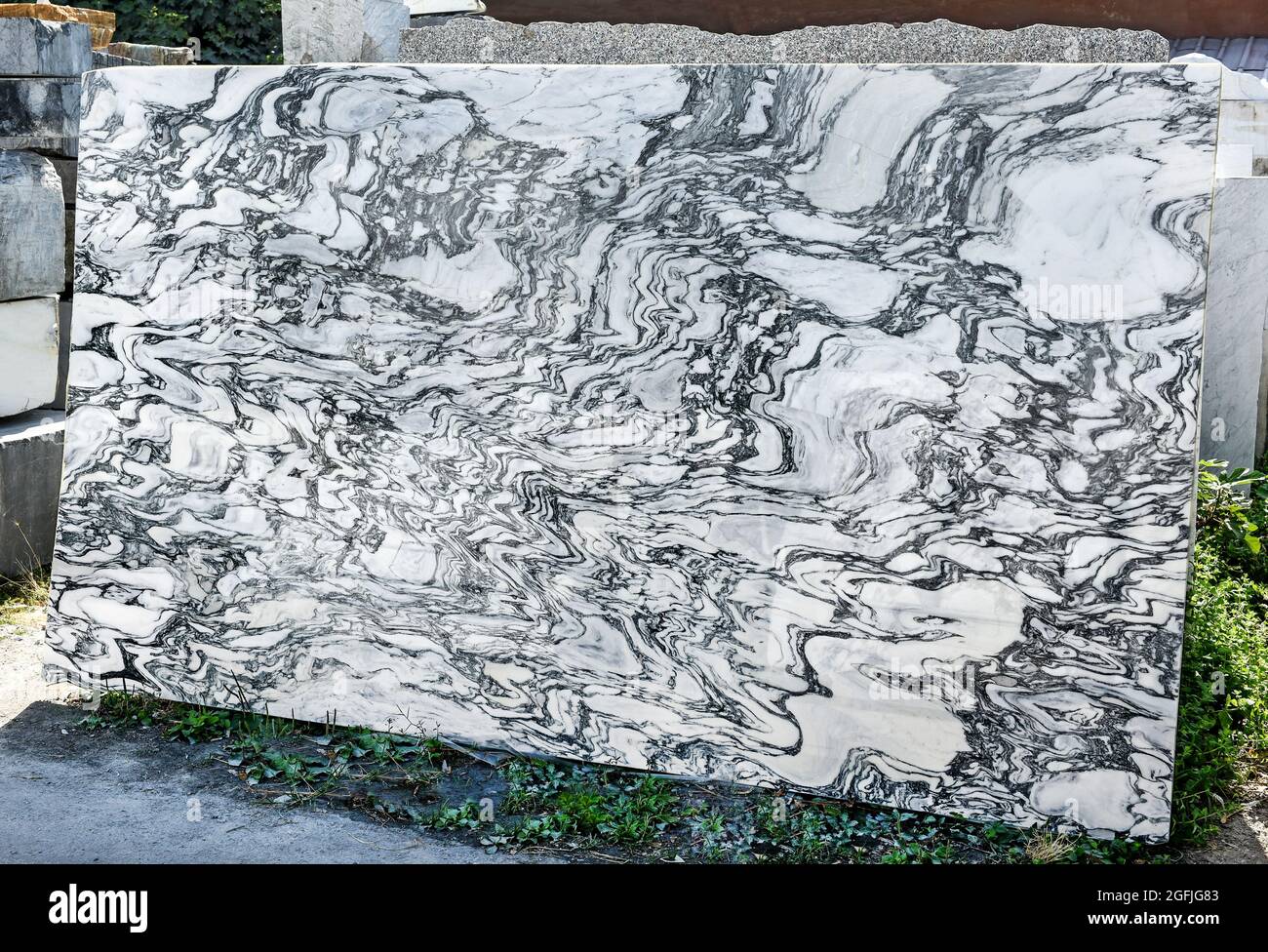 Grande lastra decorativa in marmo bianco con vene nere di Carrara, Toscana, Italia in piedi verticale all'aperto in mostra da vicino in una miniera a Foto Stock