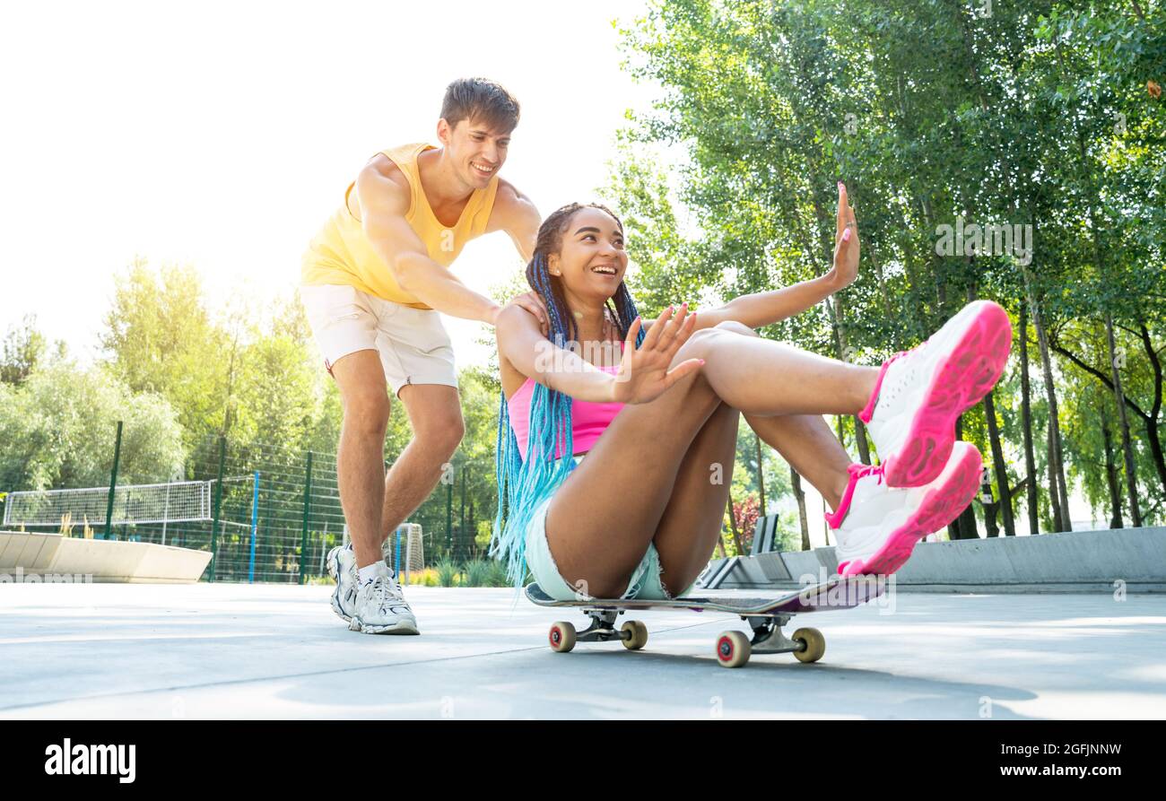 Gruppo di pattinatori adolescenti allo skatepark. Skateboarder professionisti che si divertono insieme Foto Stock