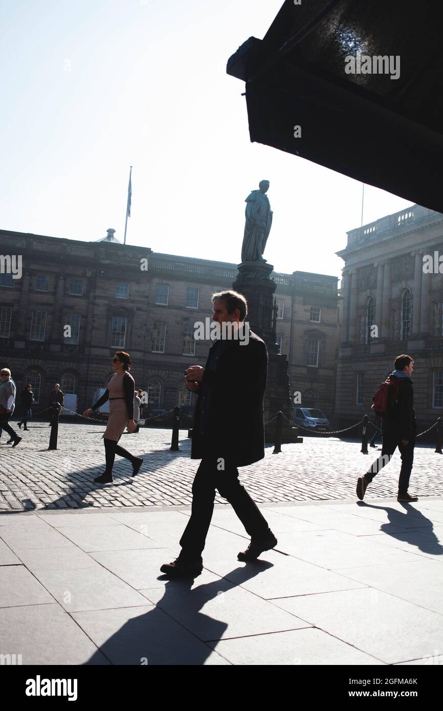 Persone che camminano per Piazza del Parlamento di Edimburgo Foto Stock