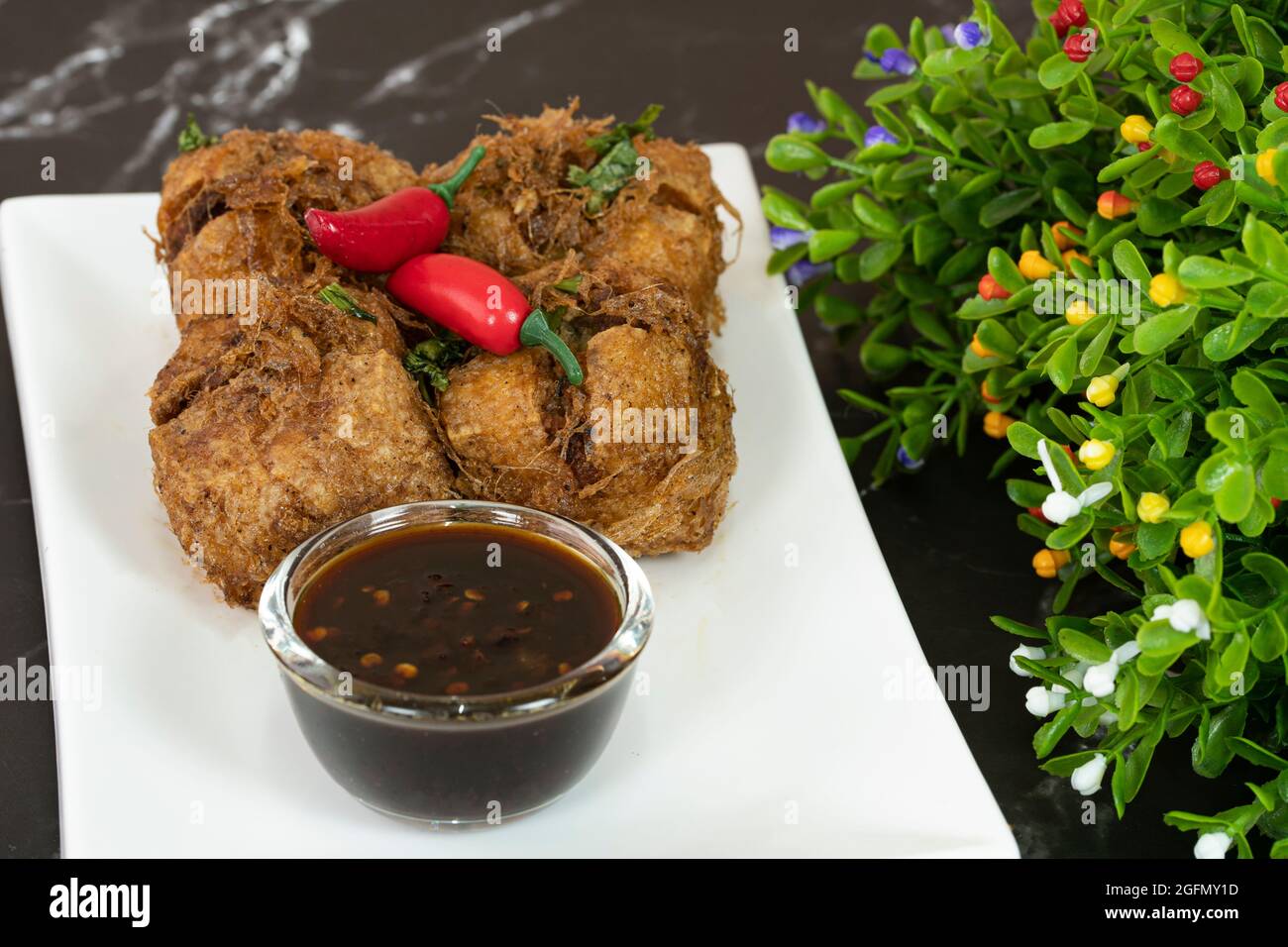 Un servizio di tauhu bergedil, un famoso piatto malese con salsa di soia piccante come salse. Sfondo sfocato Foto Stock