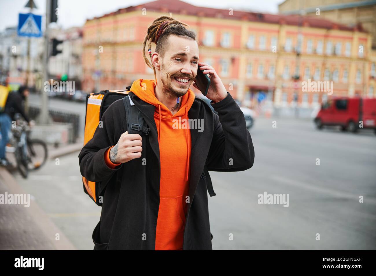 Felice uomo brunette che ha piacevole conversazione telefonica Foto Stock