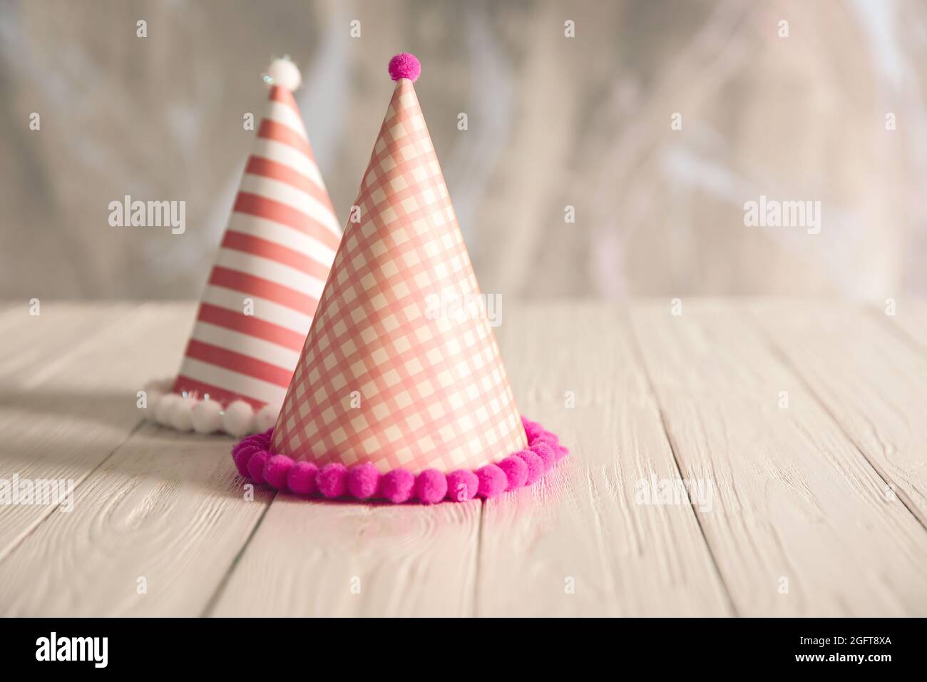 Cappellini per feste di compleanno su tavolo di legno Foto stock - Alamy