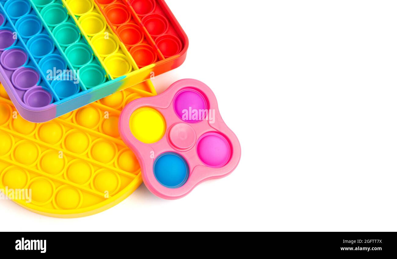 Pop IT Simple Dimple - silicone sensoriale anti-stress Fidget giocattolo colorato arcobaleno gioco isolato su sfondo bianco, spazio copia. Foto Stock