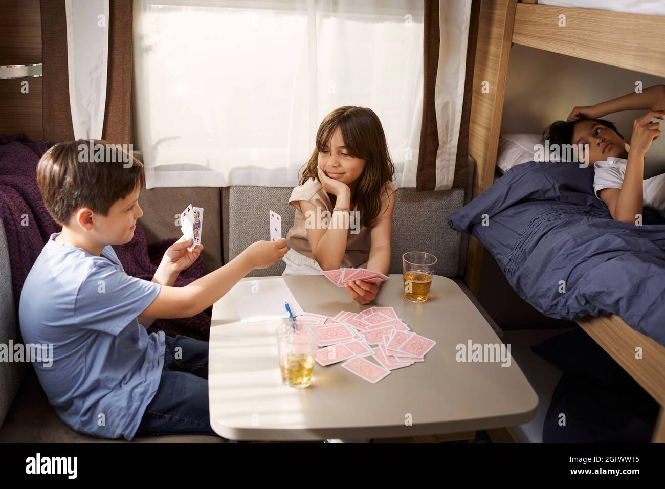 Bambini che giocano a carte in camper Foto Stock