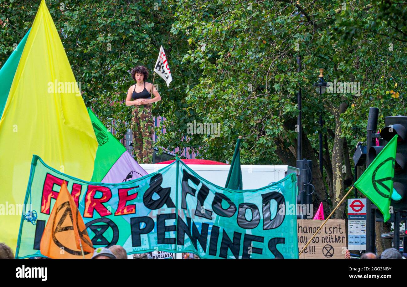 Un protessore alla ribellione d'estinzione si erge su un furgone che blocca l'incrocio di Cambridge Circus a Londra, parte di una settimana di proteste sul cambiamento climatico. Foto Stock