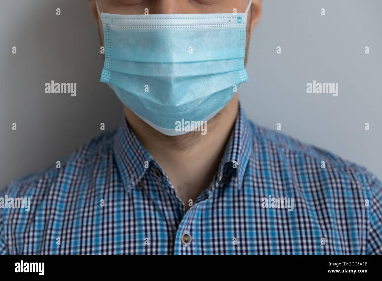 Giovane uomo caucasico in casual indossare maschera medica sul viso Foto Stock