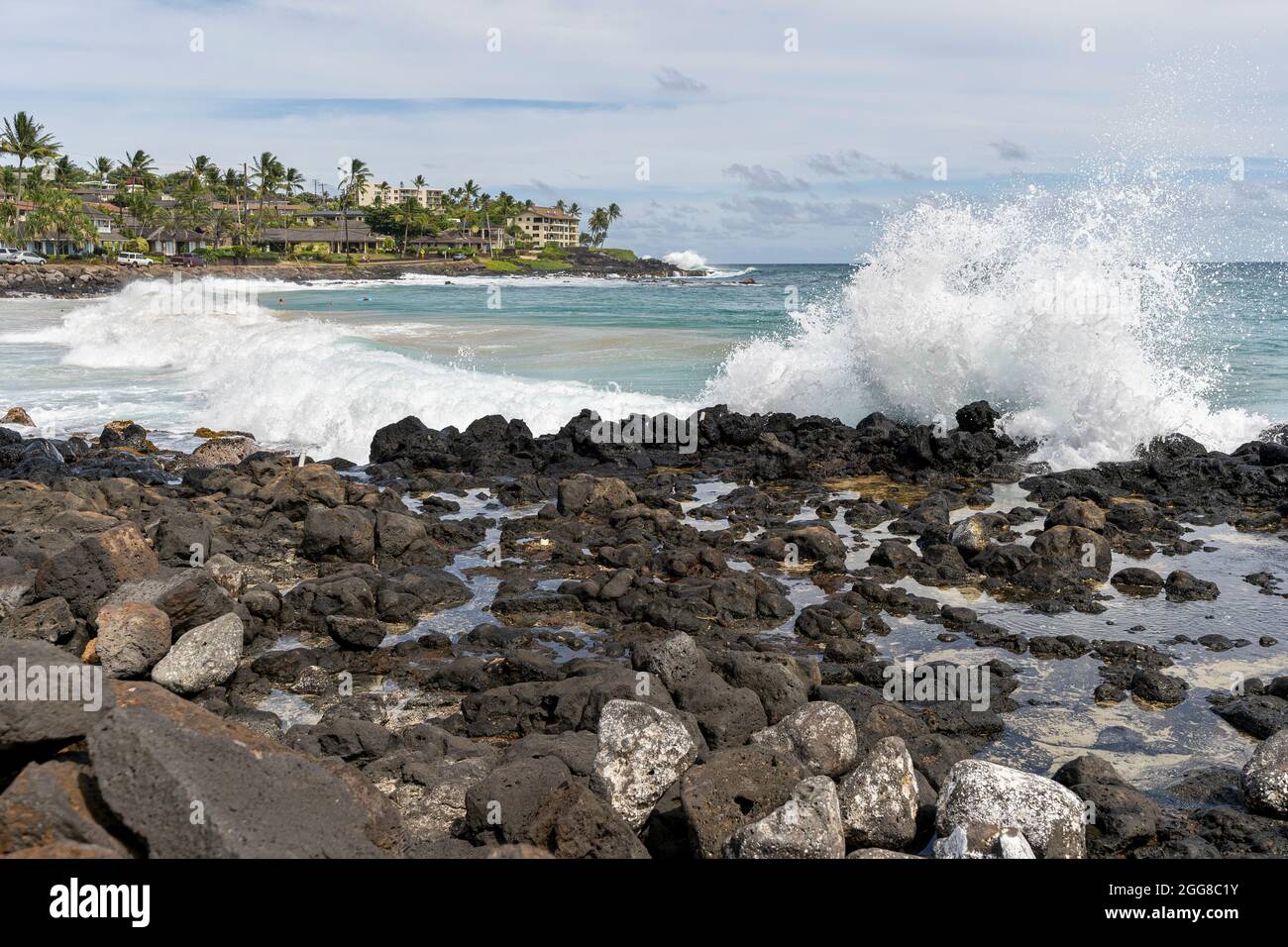 Le onde dell'oceano si infrangono sulla costa rocciosa del Poipu Beach Park a Poipu, Hawaii. Foto Stock