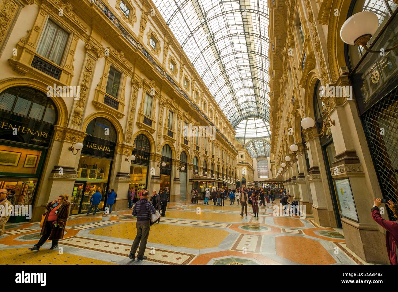 Gente passeggiando e facendo shopping lungo uno dei portici. Presso la Galleria Vittorio Emanuele II di Milano. Foto Stock