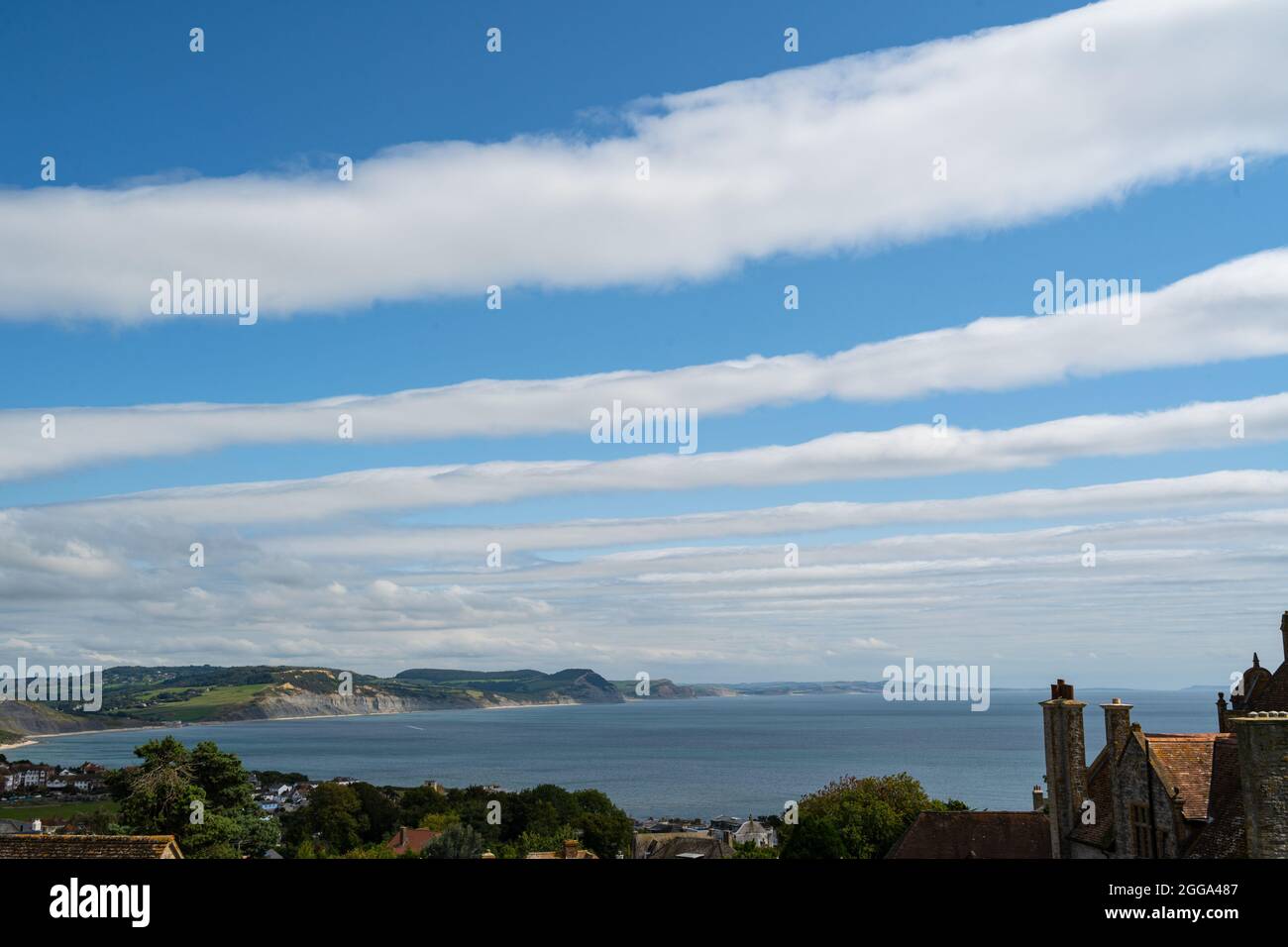 Lyme Regis, Dorset, Regno Unito. 30 ago 2021. UK Meteo: Nuvole chiaro sopra la costa Jurassic e Lyme Regis creazione di strisce nel cielo. Credit: Celia McMahon/Alamy Live News Foto Stock