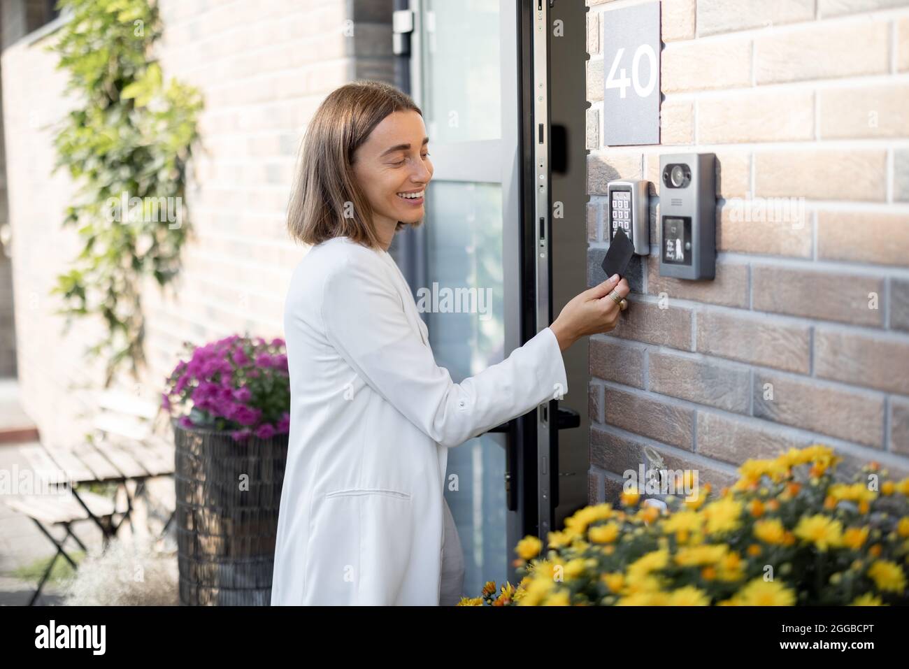 La donna ottiene l'accesso per entrare a casa con la scheda Foto Stock