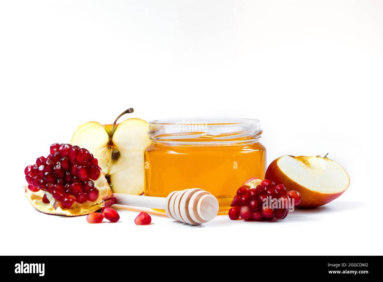 Rosh Hashanakh vacanza ebraica. Mele, melograni e miele isolati su sfondo bianco. Giudaismo tradizionale Foto Stock