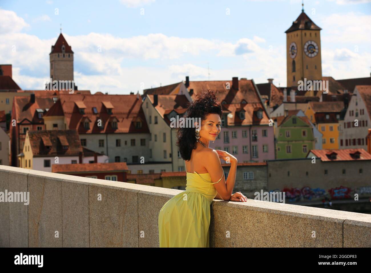 Regensburg Altstadt oder Innenstadt oder City mit schwarzhaariger Schönheit mit sinnlichen Blick und gelben Kleid. Oberpfalz, Baviera, Ratisbona. Foto Stock