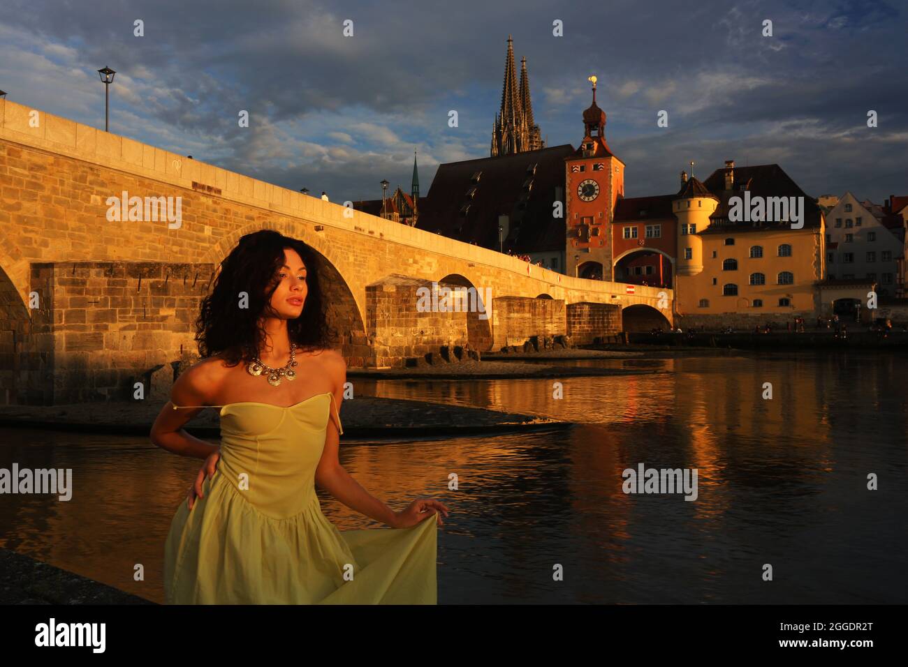 Regensburg Altstadt oder Innenstadt oder City mit schwarzhaariger Schönheit mit sinnlichen Blick und gelben Kleid. Oberpfalz, Baviera, Ratisbona. Foto Stock