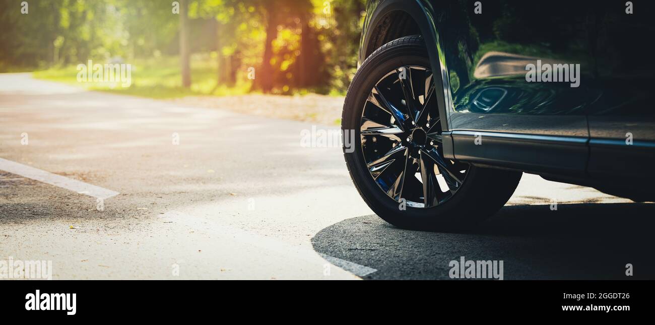 auto sportiva con cerchi in lega neri su asfalto. spazio copia Foto Stock