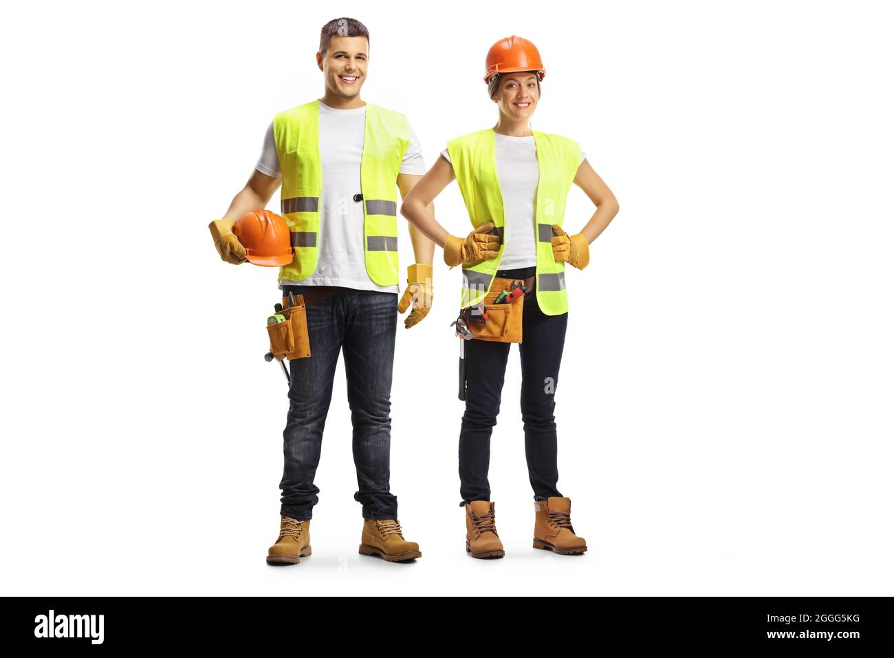 Ritratto a tutta lunghezza di un uomo e di una donna lavoratori edili che indossano i cappelli isolati su sfondo bianco Foto Stock
