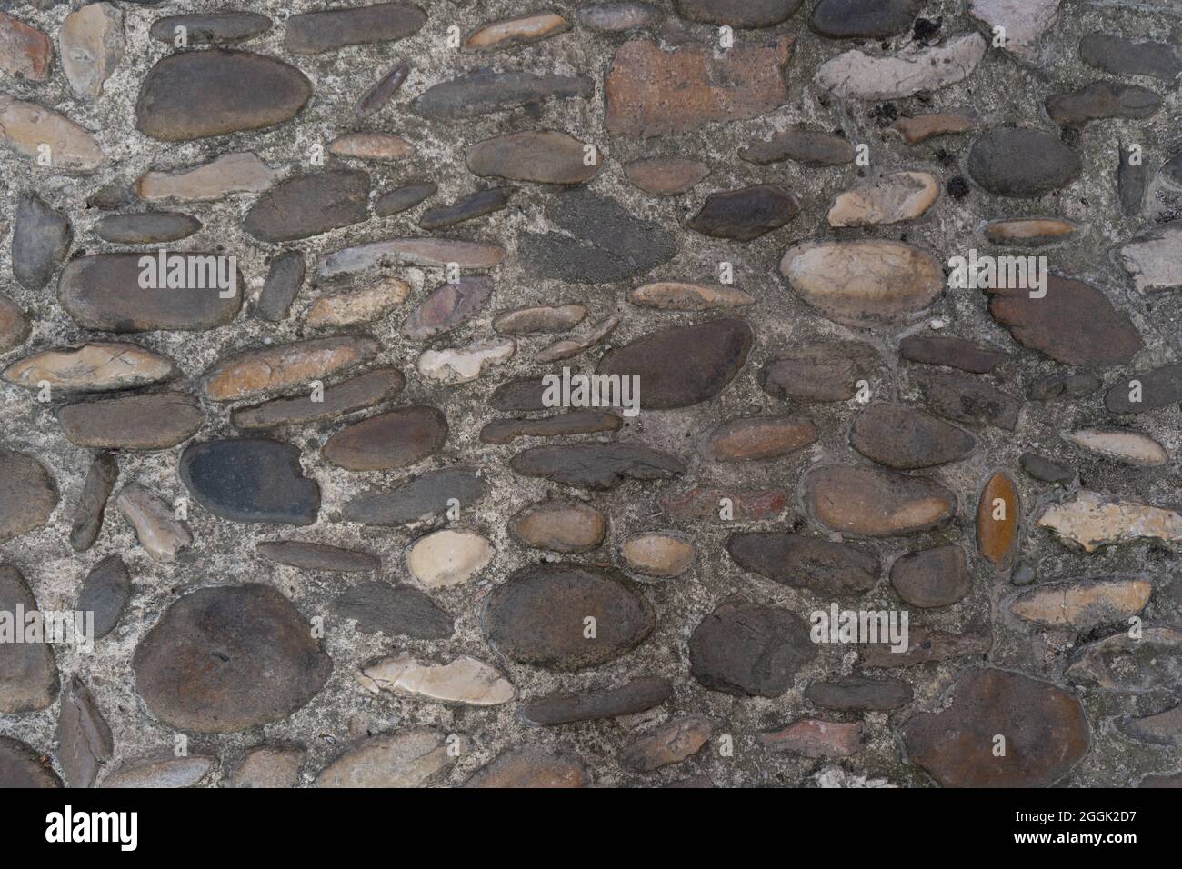 Texture di pietra muro schema background.Old europeo medievale pavimento strada acciottolato pavimentazione Foto Stock