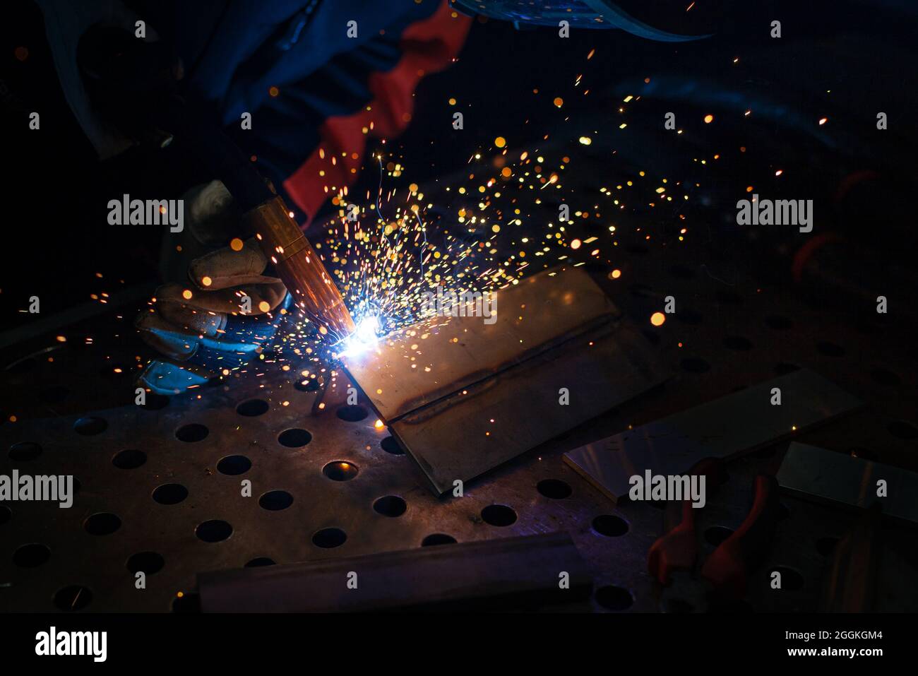 Primo piano, saldatura di strutture metalliche. Saldatura manuale semiautomatica. Saldatura MIG. Foto Stock