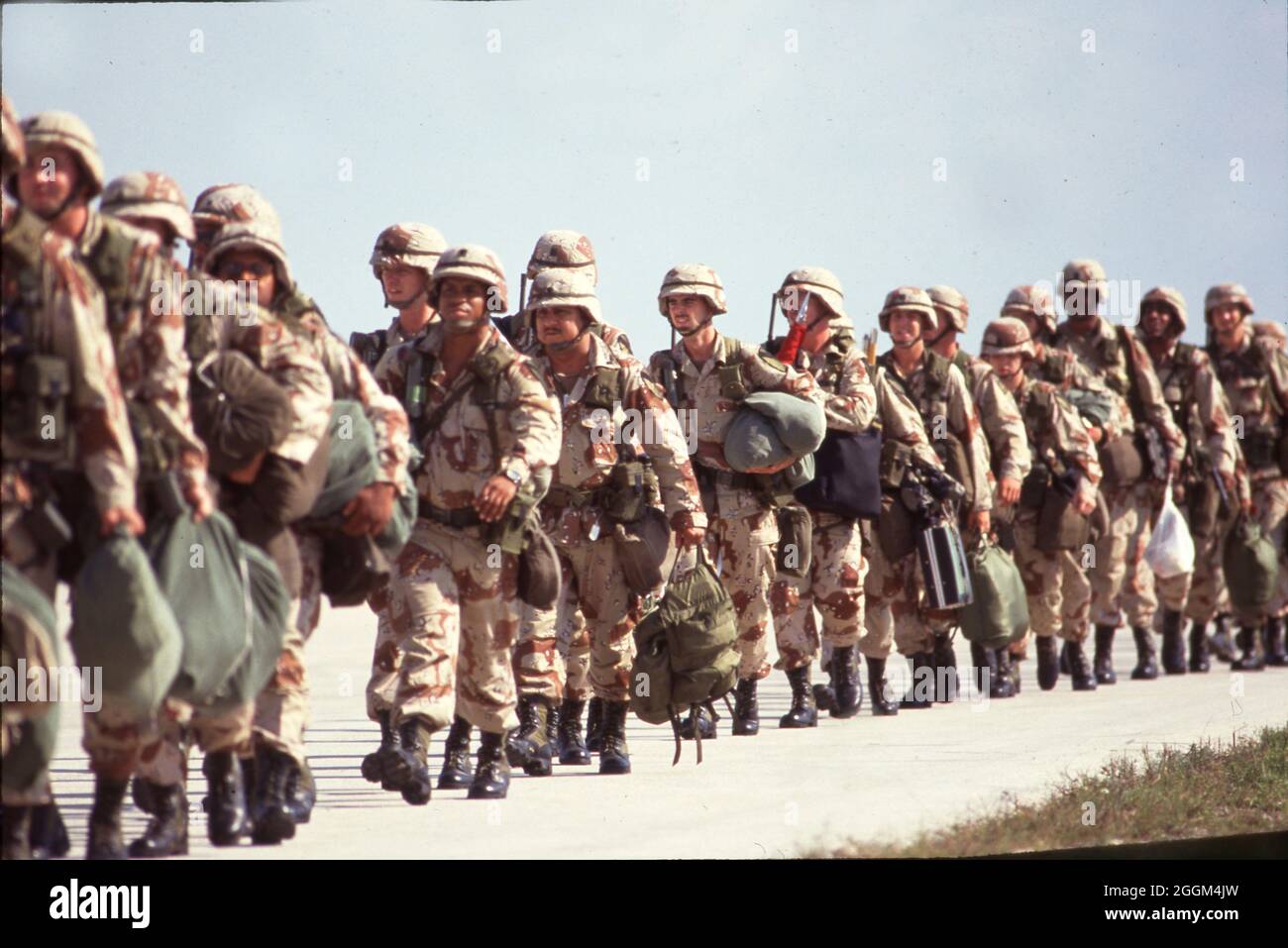 Fort Hood Texas USA, 1990: I soldati dell'esercito degli Stati Uniti che indossano uniformi di camouflage color deserto e trasportano armi e attrezzature si preparano a salire a bordo degli aerei sulla strada per servire nel conflitto in Medio Oriente. ©Bob Daemmrich Foto Stock