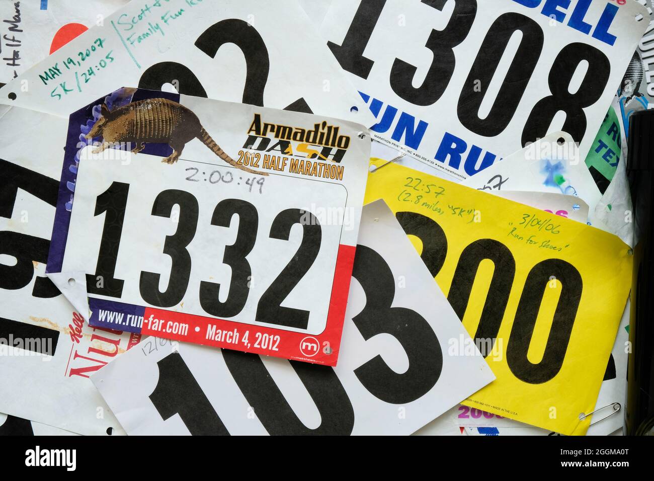 Bib assortiti e casuali da 5k e 10k corse divertenti e gare su strada competitive con risultati manoscritti, tempi e date; bib running. Foto Stock