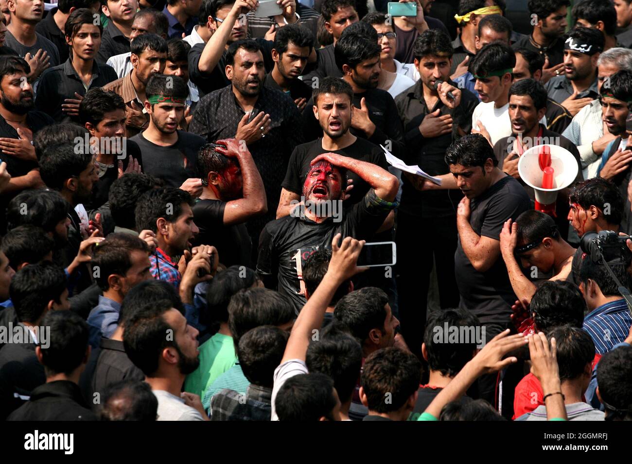 I Mulslims sciiti indiani prendono parte ad un rituale di auto flagellazione durante la processione per marcare Ashura durante il mese di Muharram a Nuova Delhi Foto Stock