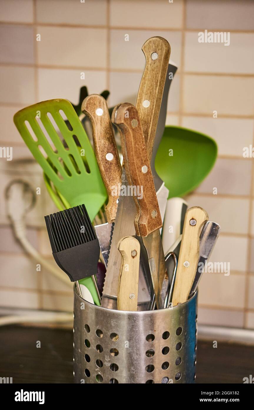 POZNA, POLONIA - Nov 21, 2017: Un mazzo di coltelli e altre attrezzature da cucina in un contenitore metallico. Foto Stock