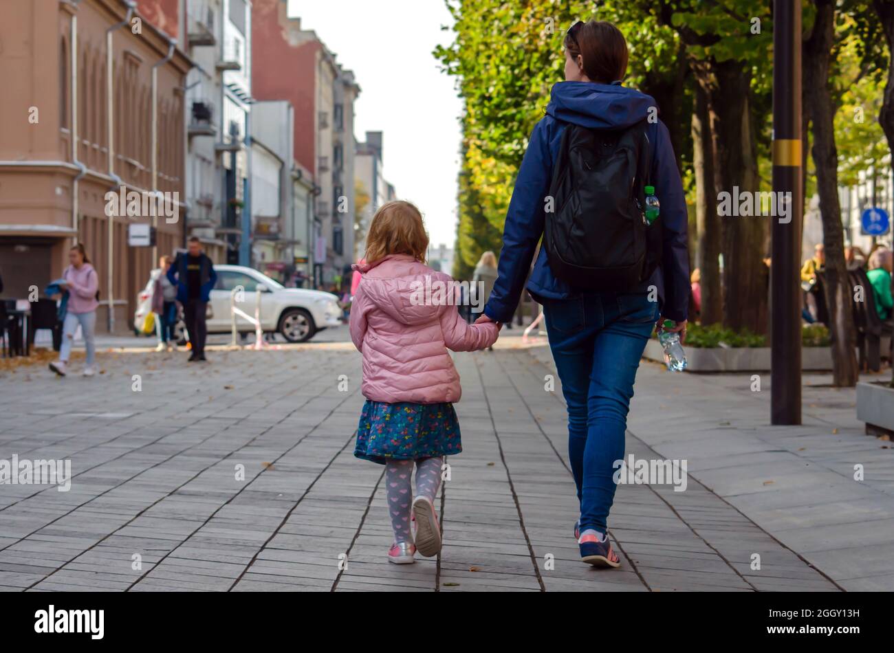 mamma e figlia stanno camminando per la città Foto Stock