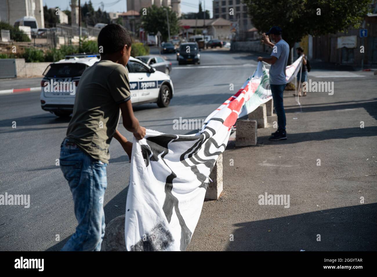 Gerusalemme, Israele. 03 Settembre 2021. Un giorno dopo che il ministro israeliano della sicurezza interna aveva dichiarato che le forze di polizia dovrebbero evitare la confisca delle bandiere palestinesi - si erano verificati scontri mentre la polizia israeliana aveva rubato violentemente le bandiere dalle mani dei manifestanti. Dimostranti ebrei e palestinesi a Sheikh Jarach durante la protesta settimanale di fronte al checkpoint della polizia israeliana all'ingresso del quartiere - che sta monitorando l'ingresso dei non residenti dallo scorso aprile. Sheikh Jarach. Gerusalemme, Israele. 3 settembre 2021. Credit: Matan Golan/Alamy Live News Foto Stock