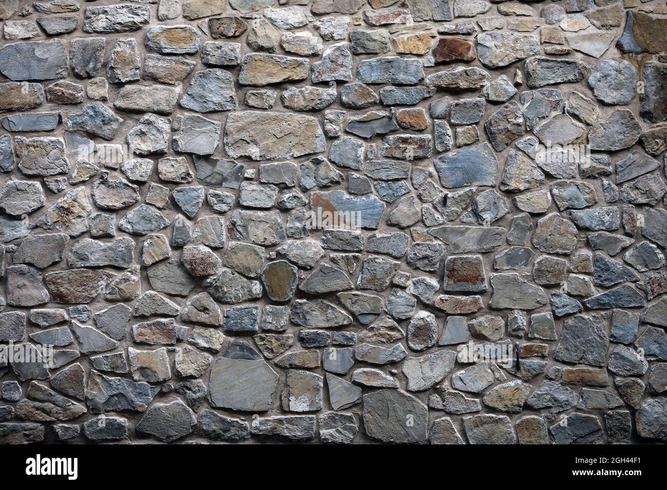Vecchia parete di materiale naturale da blocchi di granito per disegno grafico Foto Stock