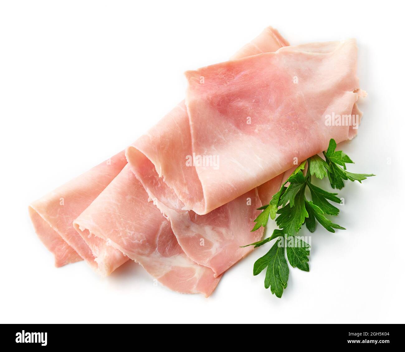 Fette di prosciutto e foglia di prezzemolo isolate su fondo bianco Foto Stock