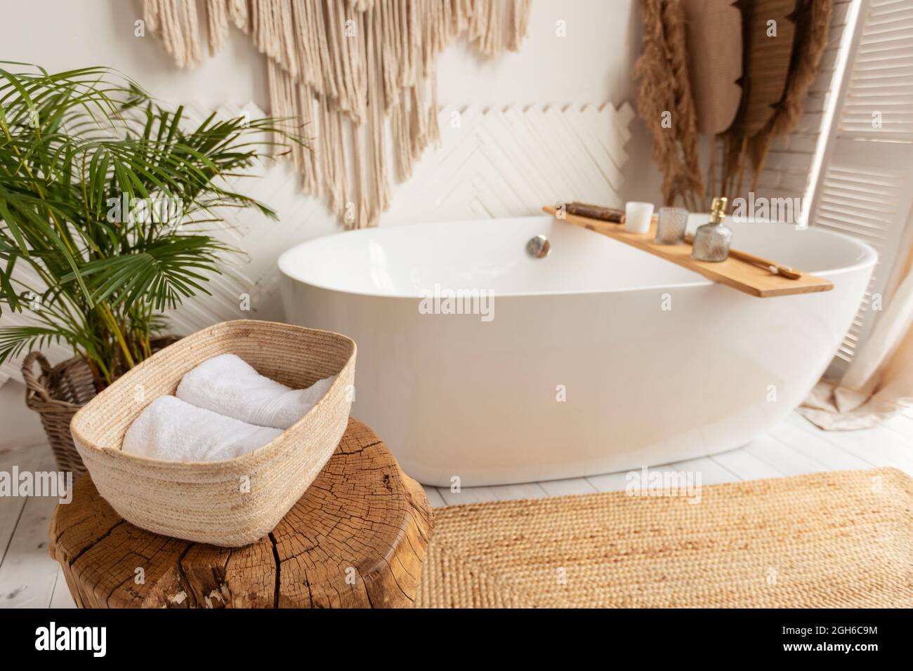 Camera da bagno con grande vasca bianca e arredi rustici Foto Stock