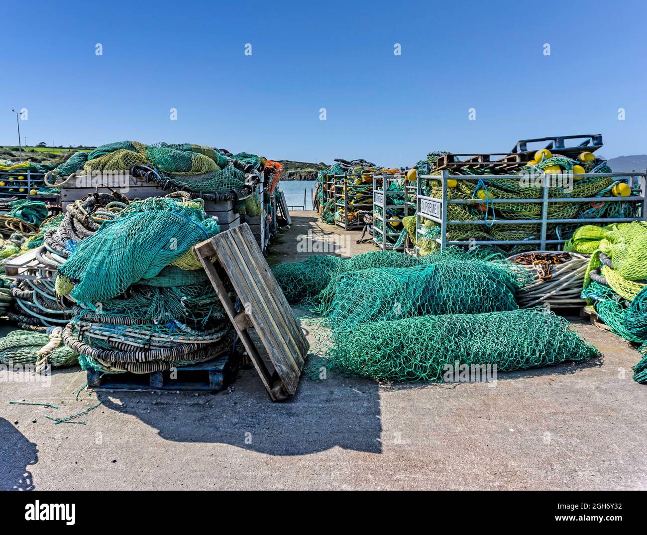 Fasci di reti da pesca e attrezzature da pesca sul molo nel villaggio di pescatori di Clogherhead, County Louth, Irlanda. Foto Stock