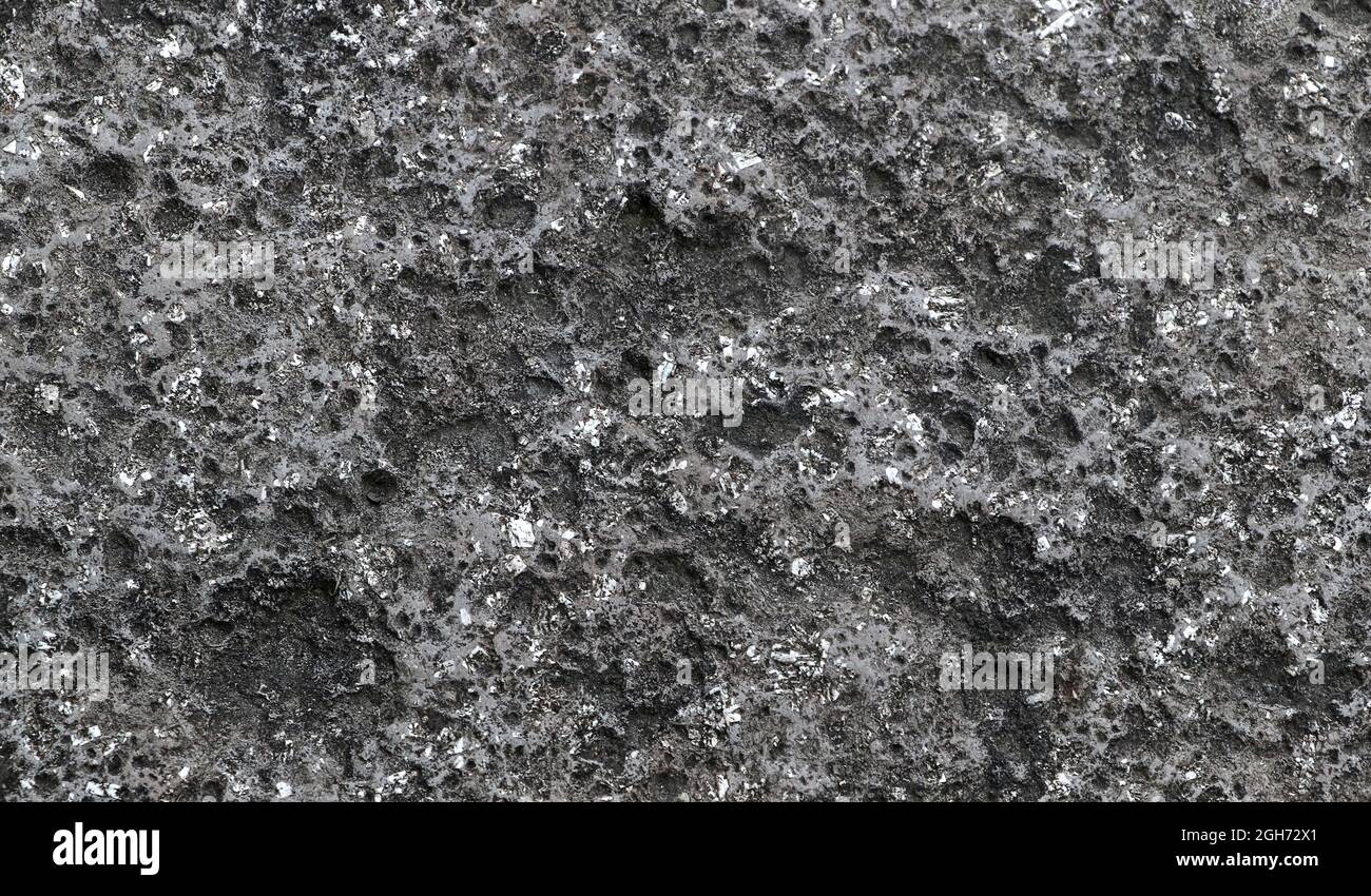 Sfondo vintage dalla texture di pietra scura. Texture in pietra nera in stile macro. Foto Stock