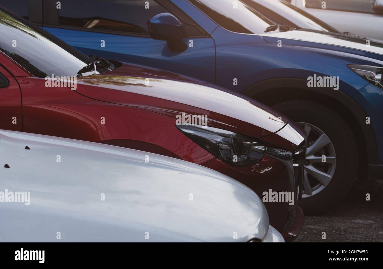 Auto parcheggiata presso il parcheggio dell'aeroporto per il noleggio. Vista laterale dell'auto SUV rossa e blu. Usato auto di lusso per la vendita e il servizio di noleggio. Parcheggio auto Foto Stock