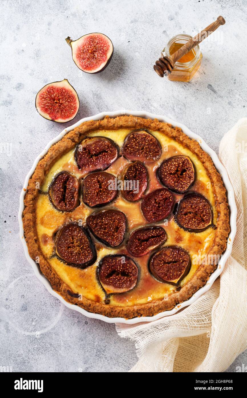 Fig. Tart. Deliziosa crostata con fichi freschi e formaggio di capra su un rustico tavolo in legno. Vista dall'alto Foto Stock