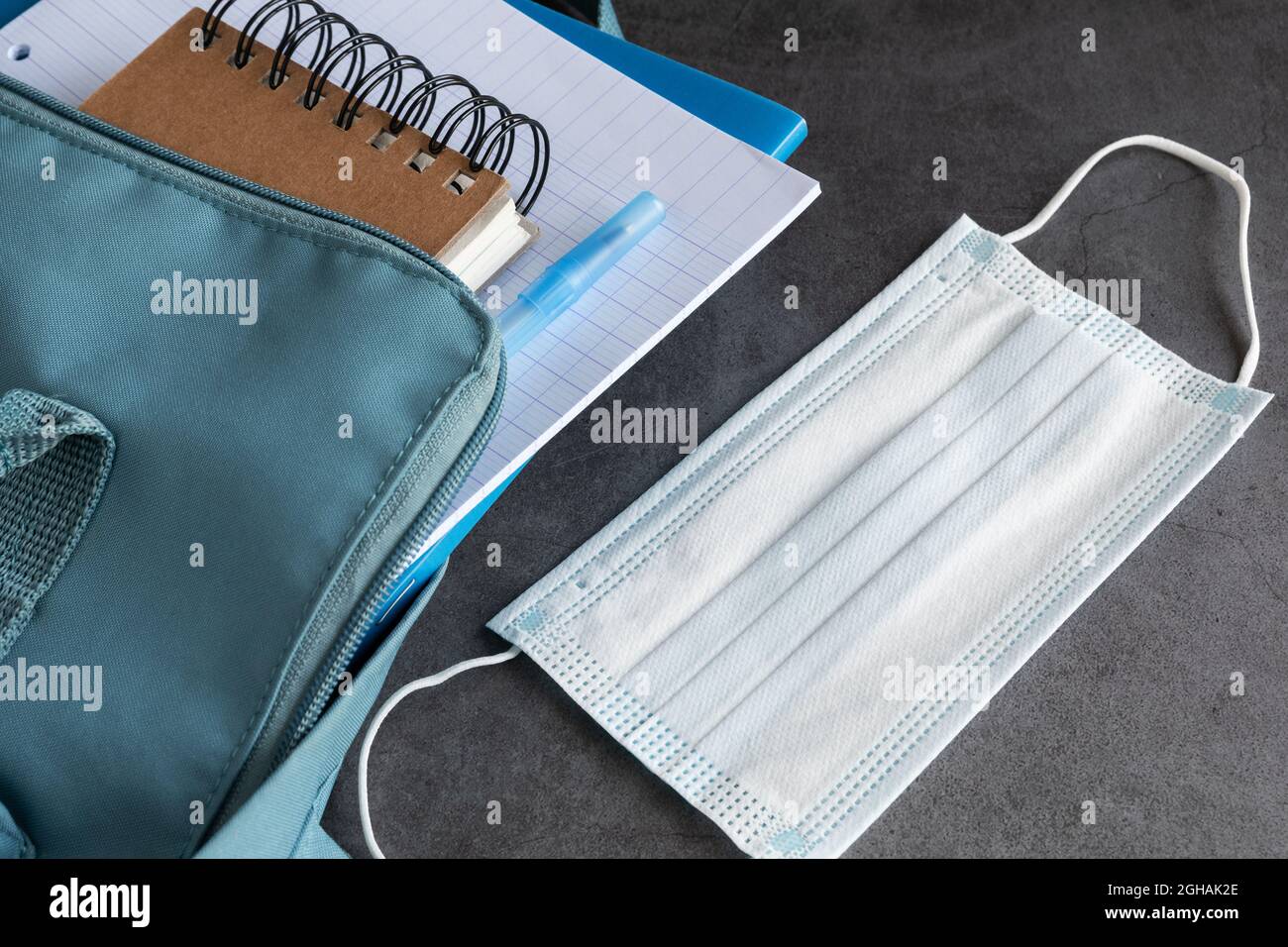 Maschera in zaino con libri Foto Stock