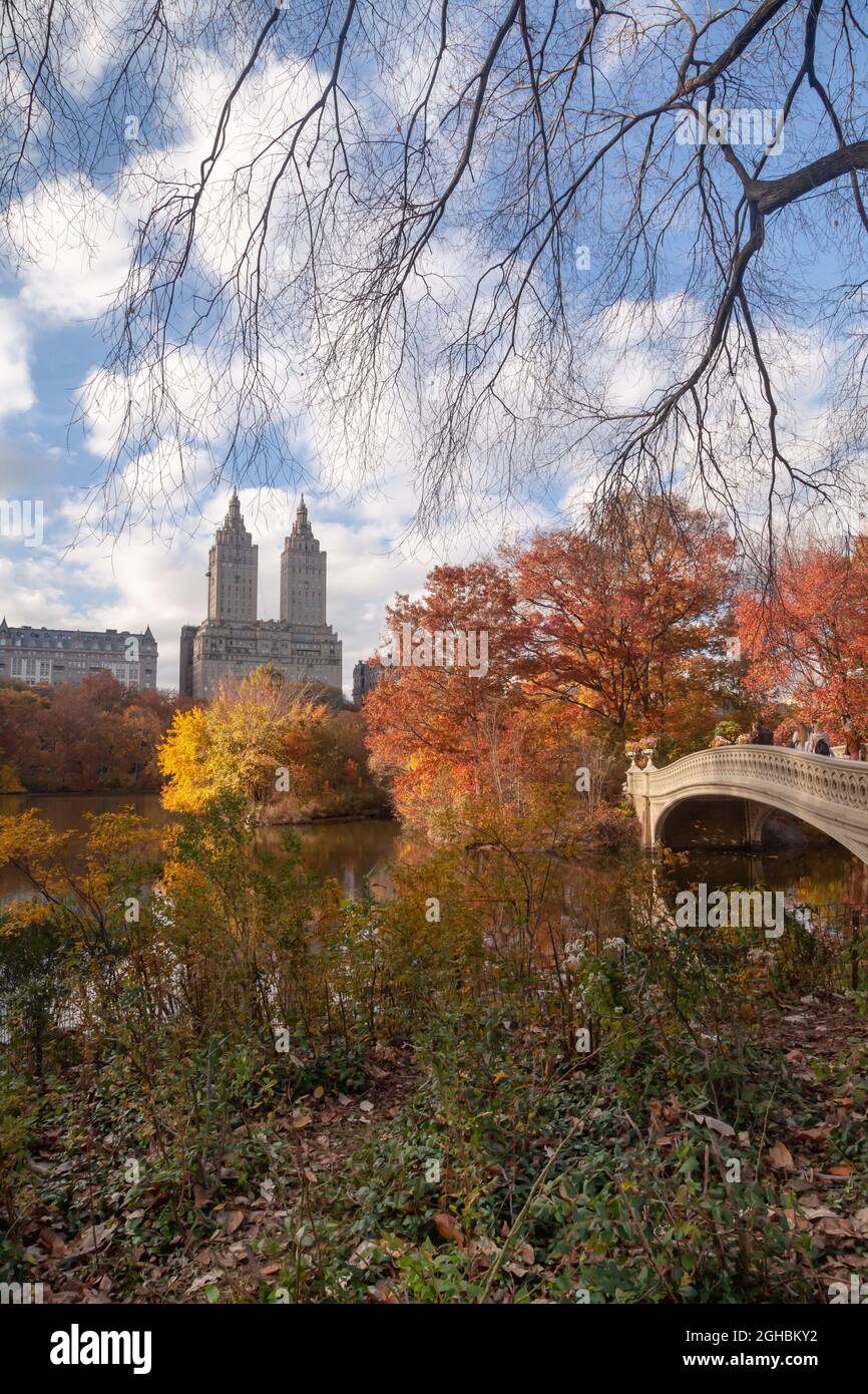 Central Park in autunno con vista della Bow Bridg e dell'alto skyline residenziale di Manhattan West Side. Ponte di prua e edificio Eldorado sul backgrou Foto Stock