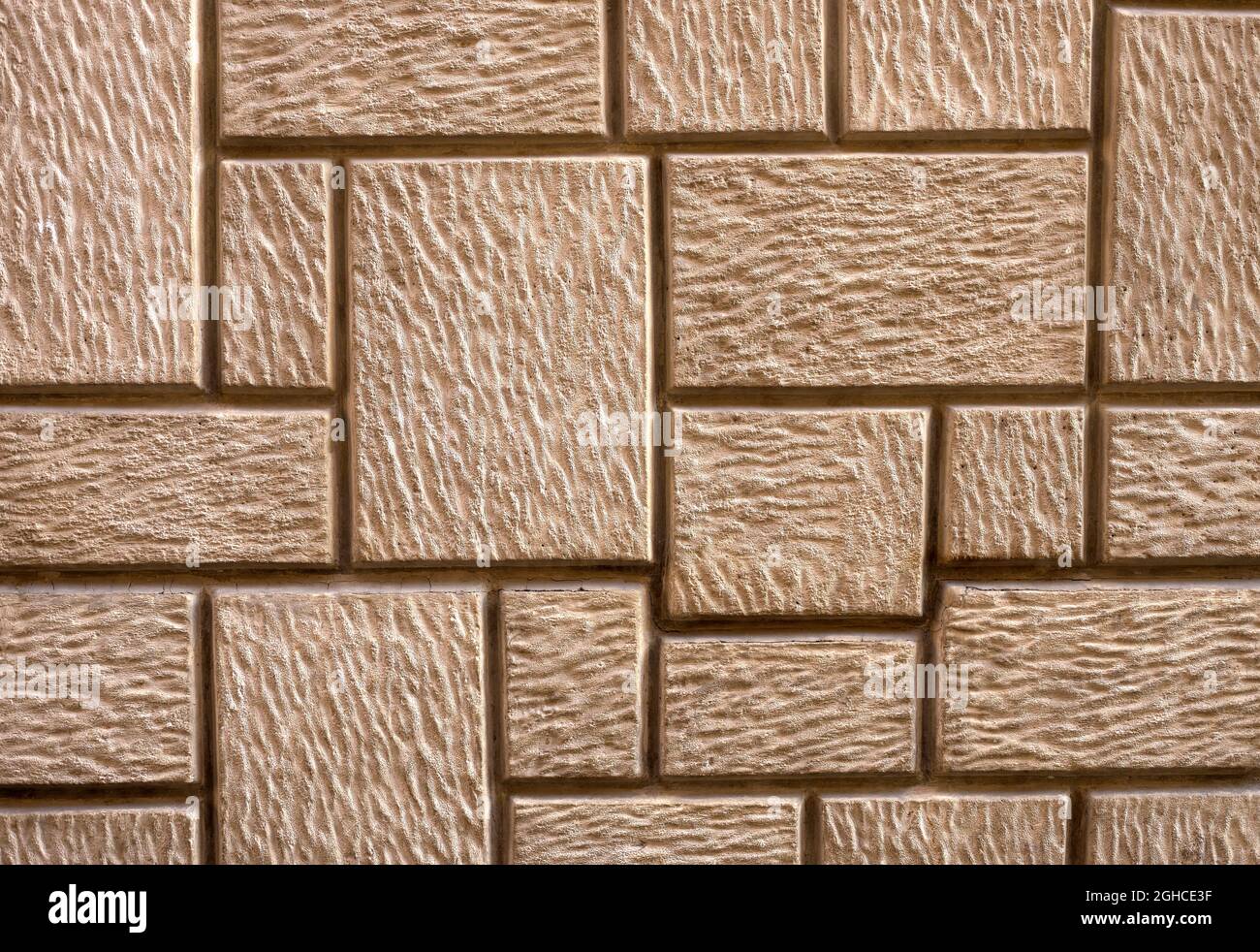 particolare di una parete di cemento, a forma di pietra marrone e beige Foto Stock