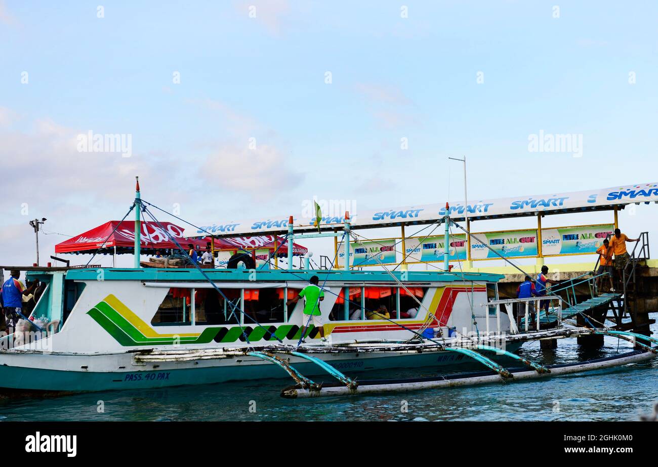 Barche locali che prendono turisti e locali a Boracay, le Filippine. Foto Stock