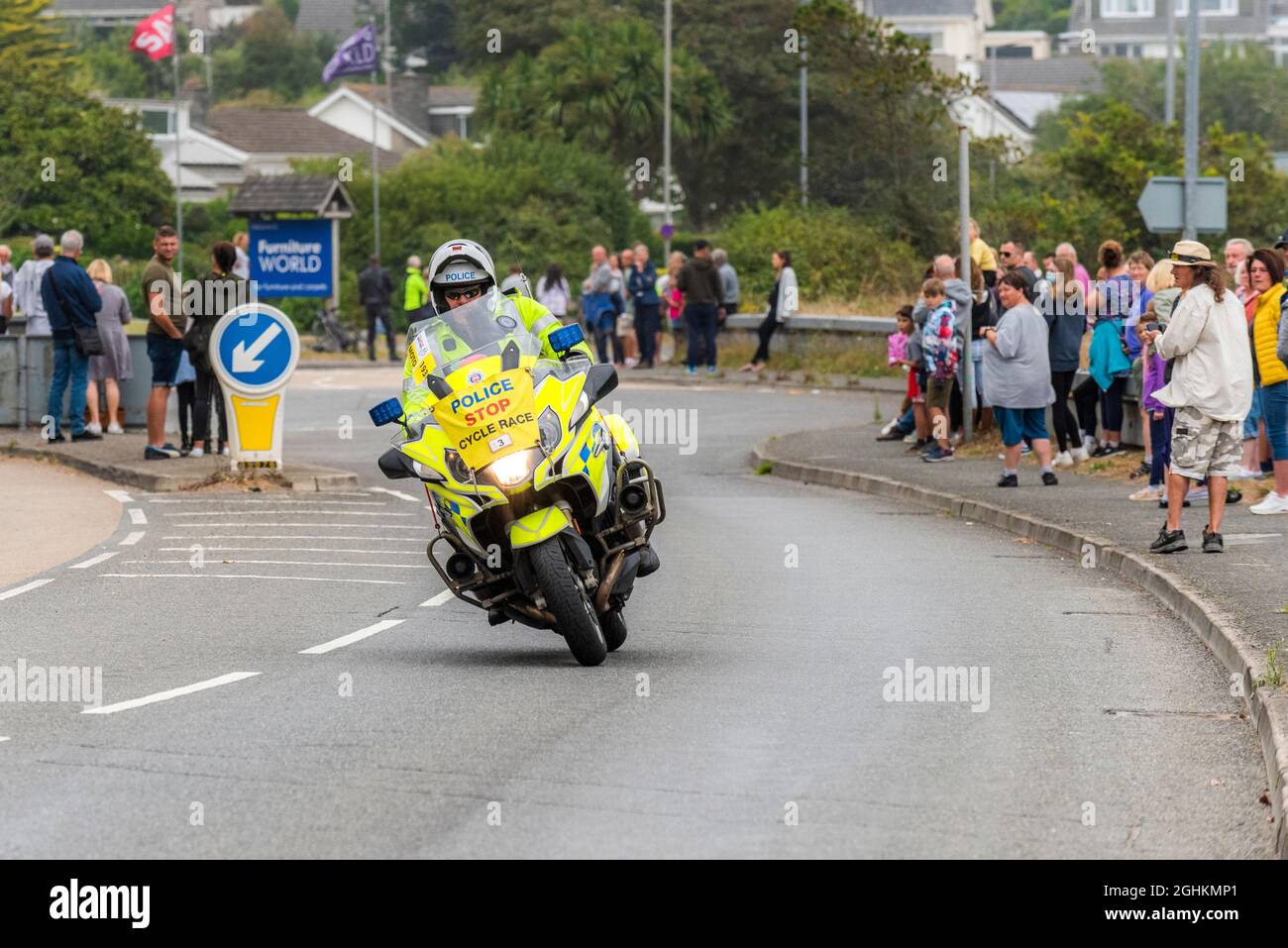 Un motociclista polic pattuglia che guida a Newquay in Cornovaglia durante la fase di apertura del iconico Tour of Britain 2021 - noto come Grand parti. Foto Stock