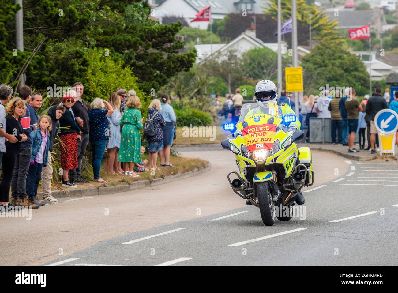 Un motociclista polic pattuglia che guida a Newquay in Cornovaglia durante la fase di apertura del iconico Tour of Britain 2021 - noto come Grand parti. Foto Stock