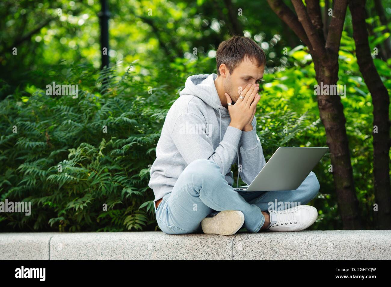 L'uomo infelice frustrato ha letto il email con le notizie difettose, i problemi sul lavoro o il fallimento finanziario inatteso Foto Stock